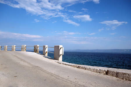 road by the sea with island in distance