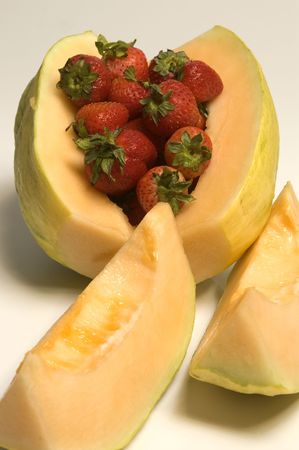 exotic crenshaw melon with strawberriesの写真素材