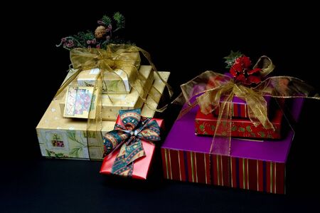 wrapped gift boxes with ribbons and bow and flowers