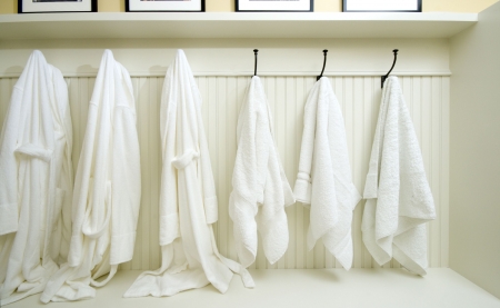 bathrobes towels hanging in a custom locker roomの写真素材