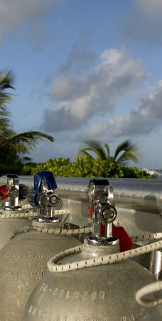 scuba tanks at dive resort with palm treesの写真素材