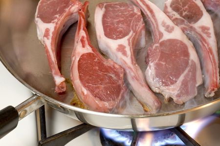 rib lamb chops meat primecooking in frying pan steam rising