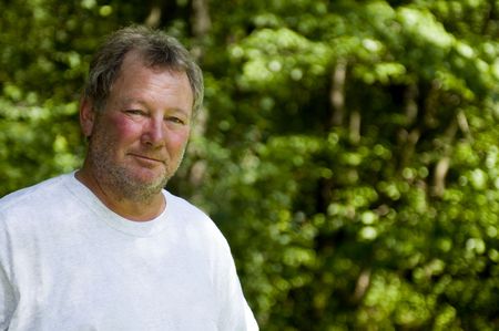 happy smiling -boomer middel age man wooded backyard background ...