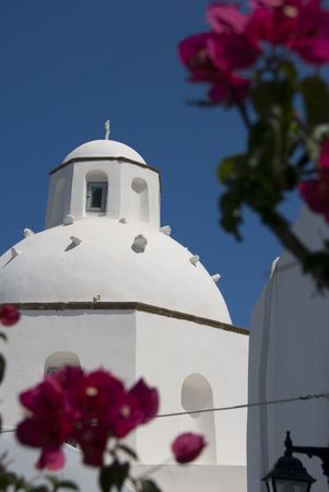 greek island church cyclades architecture with dome greece and flowers santorini の写真素材