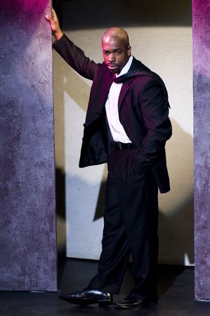 handsome black african american male stage actor model portrait pose theater stage lighting tough  の写真素材