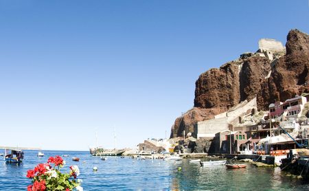 amoudi bay the fishing harbor port built into the caldera on the greek cyclades island of santorini town of oia ia on the mediterranean seaの写真素材