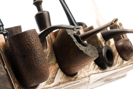 variety of pipe collection on modern pipe rack on white backgroundの写真素材