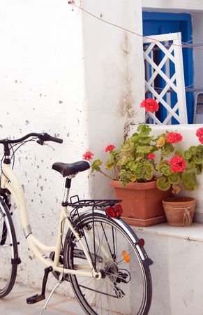 Greek Island street scene bicycle with flowers against typical architecture white-washed building Antiparos Cyclades Greeceの写真素材