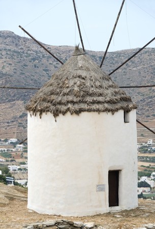 windmill Ios Island Cyclades Greece with thatch roof and white stucco architectureの写真素材