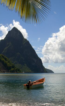  St. Lucia island view of famous twin piton mountain peaks from Soufriere beach native fishing boats in Caribbean Seaの写真素材