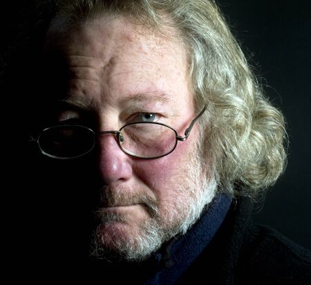 portrait of long hair senior middle age handsome man with beard