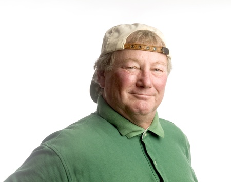 smiling handsome happy middle age senior man wearing casual hat backwards and green polo shirt