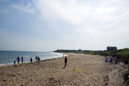 MONTAUK, NEW YORK-JUNE 8: Beachgoers and girl seen flying kite on Ditch Plains Beach, Montauk, The Hamptons, New York on June 8, 2018.のeditorial素材