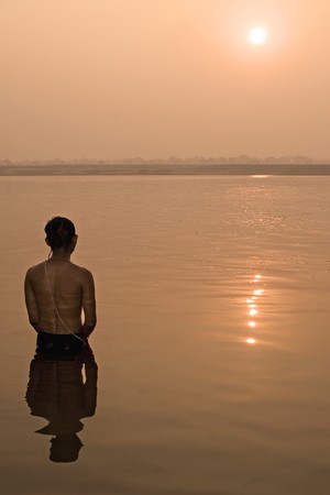 Hindu pilgrim take a bath in the ganges river in Varanasi, India.の写真素材