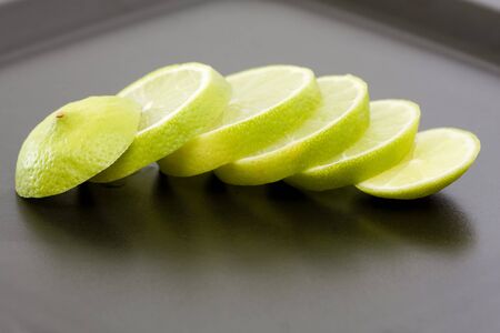sliced lime at a black dinner plate