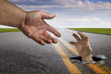 Asphalt pavement through green grass meadowの写真素材