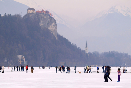 LAKE BLED, SLOVENIA - FEBRUARY 12 2012: Families enjoying a frozen Lake Bled.のeditorial素材