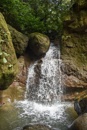 Waterfall in the jungle with rocksの写真素材
