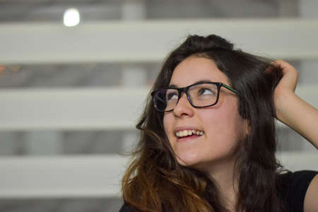 beautiful girl smiling with glasses and black blouseの写真素材