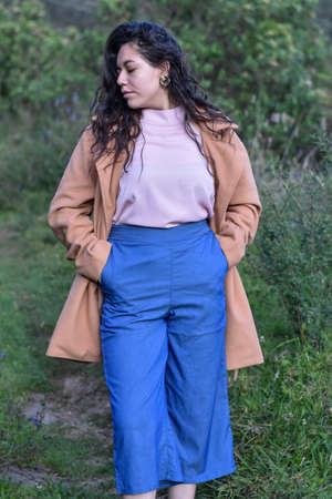 Model woman poses in nature wearing elegant clothesの写真素材