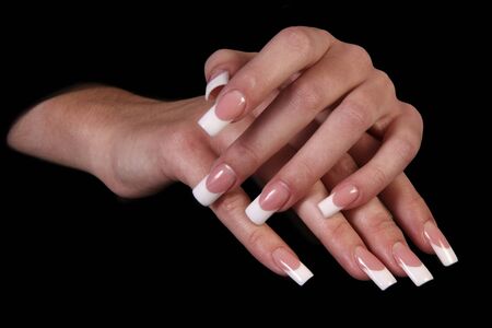 Human fingers with long fingernail and beautiful manicure isolated on black の写真素材