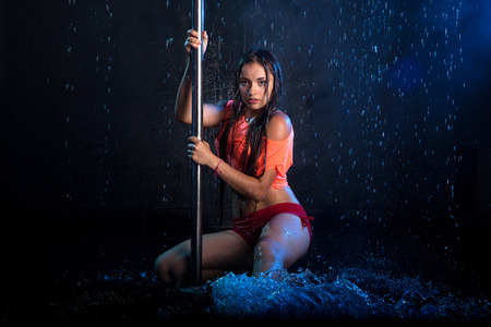 Young sexy woman pole dancer. Water studio photoの写真素材