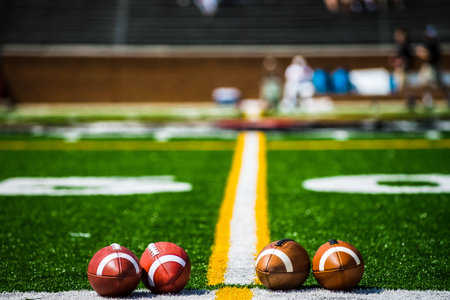 footballs on sideline,50 yard marker into the distance