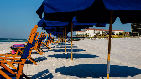 Beach chairs and umbrellas on a sunny day on the beach at Ft. Walton Beach FLの写真素材