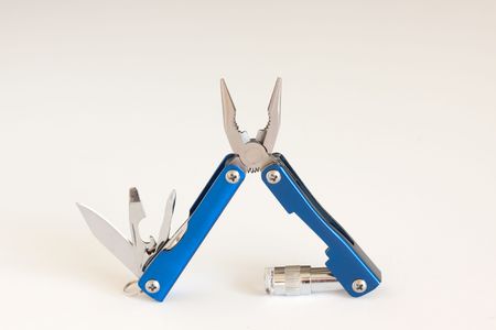 Open blue pocket utility tool with cutter,LED light and assorted blades