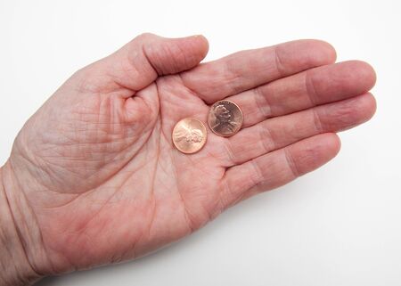 Hand holding two pennies over white representing the concept My Two Cents Worth