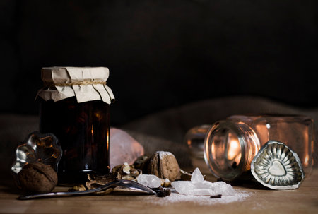 Still life with Christmas baking ingredients - nuts, sugar crystals, cookie molds on wooden board - photo with selective focusの写真素材