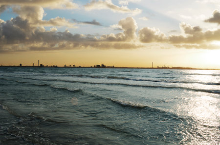 Photo of sea with sunset sky with cloudsの写真素材