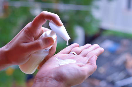Woman applying hand sanitizer cleaning hands to helping protect from covid-19