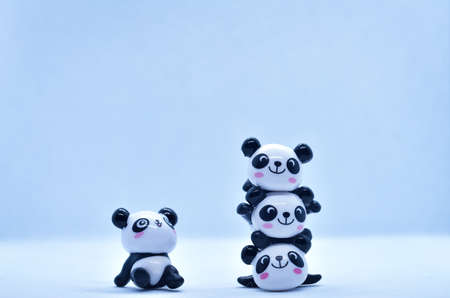 Little panda porcelain figurines isolated on black backgroundの写真素材