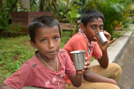 Mumbai, India - October 27, 2015 - Children from children«s home drinking water from new well powered by charity from europeのeditorial素材