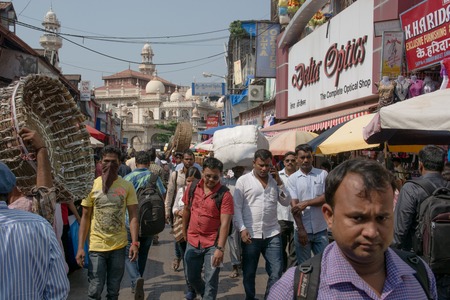 Mumbai, India - October 19, 2015 - Muslim area Bhendi Bazaar with mosque in background with people moving slowly in the very crowded streets and traffic in Mumbai with tuk tuk and taxisのeditorial素材
