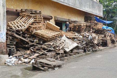 Kochi, India - November 7, 2015 - Indian boy working in company that recycles palletsのeditorial素材