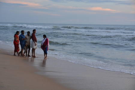 Varkala, India - November 5, 2015 - People and pilgrims praying at holy beach Varkala in Kerala, South India and taking a bath in the holy waterのeditorial素材