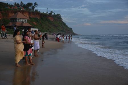 Varkala, India - November 5, 2015 - People and pilgrims praying at holy beach Varkala in Kerala, South India and taking a bath in the holy waterのeditorial素材