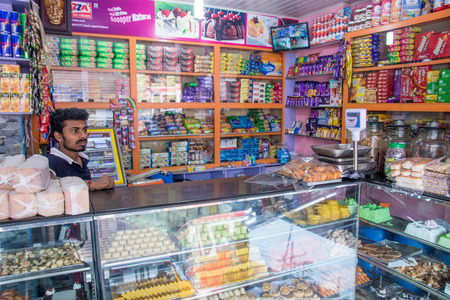 Mumbai, India -December 11, 2016 - Indian trader in his shop on local market selling all kind of goodsのeditorial素材