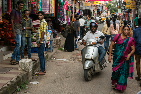 Mumbai, India - December 11, 2016 - Man pulling a cart with pallets slowly in the very crowded streets and traffic in Mumbai with tuk tuk and taxisのeditorial素材