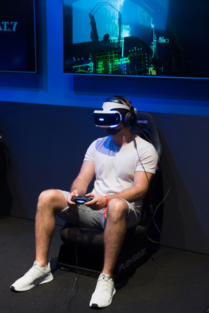 Cologne, Germany - August 26, 2017 - Young people playing flight simulator with virtual reality eyeglassesのeditorial素材