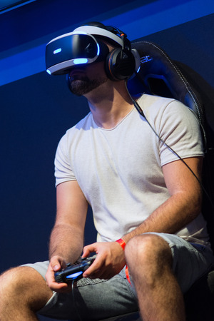 Cologne, Germany - August 26, 2017 - Young people playing flight simulator with virtual reality eyeglassesのeditorial素材