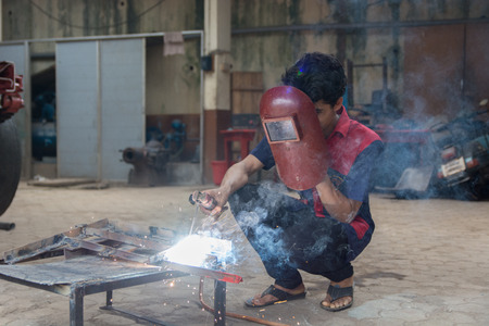 Mumbai, India - July 8, 2018 - Indian boys learning about welding in vocational schoolのeditorial素材