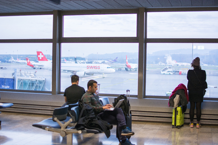 Munich, Germany - July 8, 2018 - Passengers waiting at airport in front of arrival departure board in Munichのeditorial素材