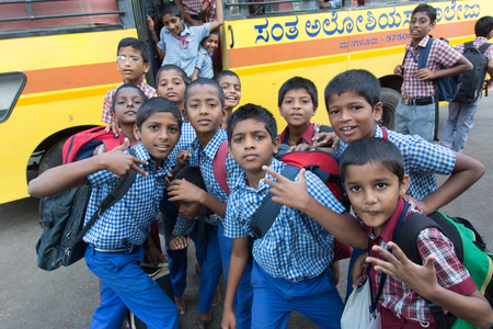 Mumbai, India - July 8, 2018 - Children from childrens home waiting for yellow school bus paid by an...