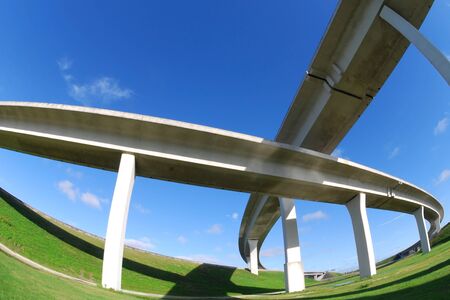Sweeping expressway on clear blue skyの写真素材