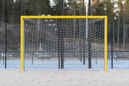 Yellow soccer or handball goal on a sand pitchの写真素材