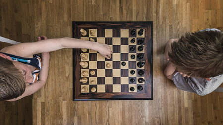 Two boys playing chessの写真素材