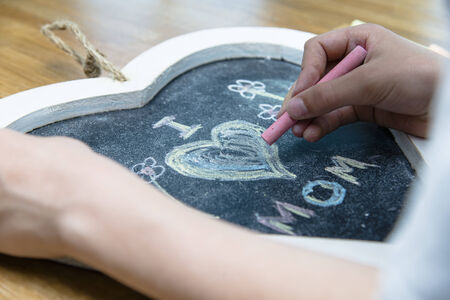 Boy writing I love mom for mother
